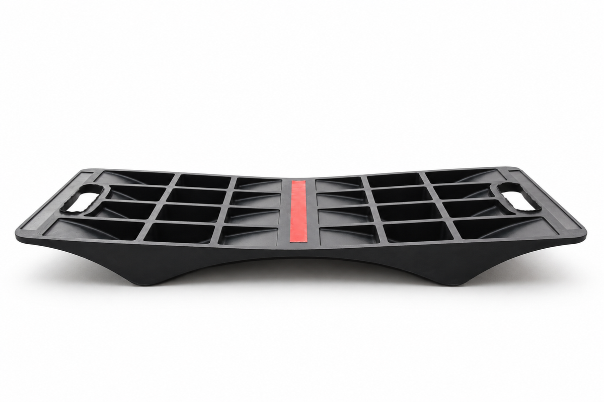 Low side view of the heavy-duty double-sided parking mat underside and adhesive strip