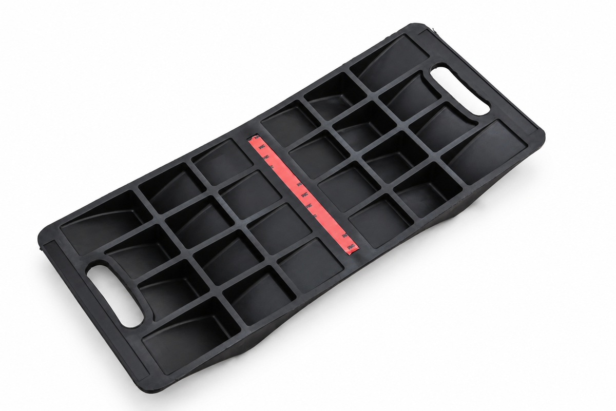 Heavy-duty double-sided parking mat underside with reinforcing ribs, carry handles and adhesive strip