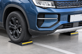 Front vehicle view with both front tires positioned on heavy-duty single-sided parking mats