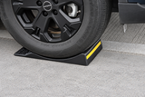Side view of a vehicle tire positioned against the raised stop of a heavy-duty single-sided parking mat